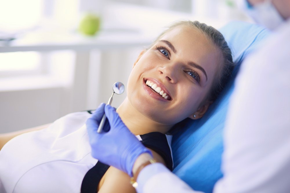 blond teen girl smiling sitting in dental chair for exam, general dentist Magnolia, TX